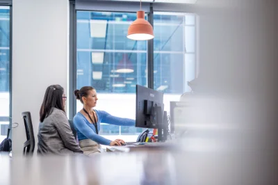 Two People working at a computer in an office